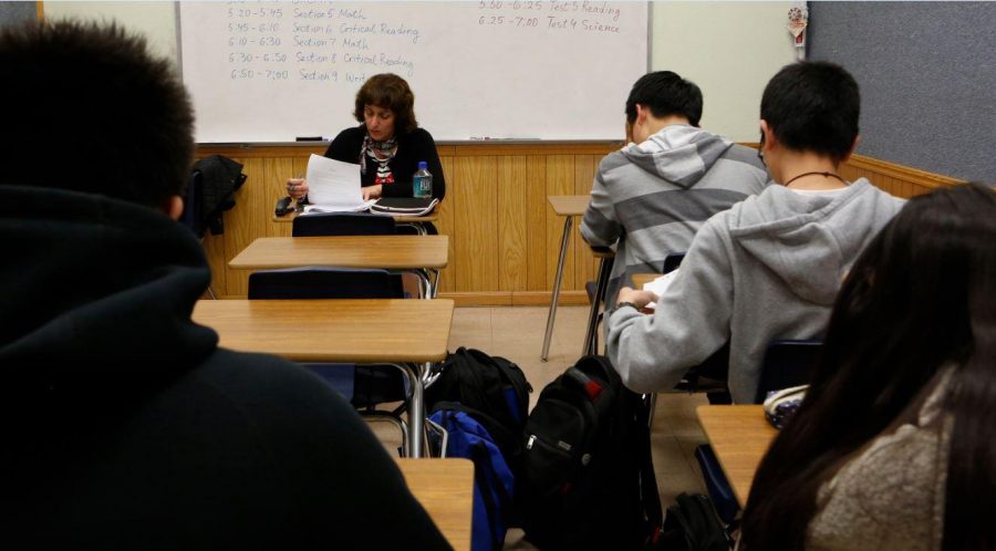 Teacher Svetlana Djananova monitors students as they take an ACT test. Affirmative action is said to be a “positive discrimination,” but what it actually does is discriminate the minority. This illustrates how US has flaws in their Civil Rights Acts. 