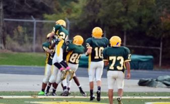 Pictured is: 10 Jackson Rudd, 24 Caedmon Ferrell, 80 Jacob Vayo-Smith, farthest left: Ryan Draughn. The team celebrates after scoring a touchdown. Football is an incredibly dangerous sport and has many risks, which these players know all too well. However, they continue to play despite these risks. 