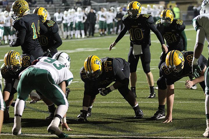 Now junior quarterback Jake Borman is getting the huddle ready before a play during last years game v Mason on Oct. 31, 2014. SHS ended up winning the game and stopped Mason from making the playoffs. The team looks to do it again this year but not on their home turf. 