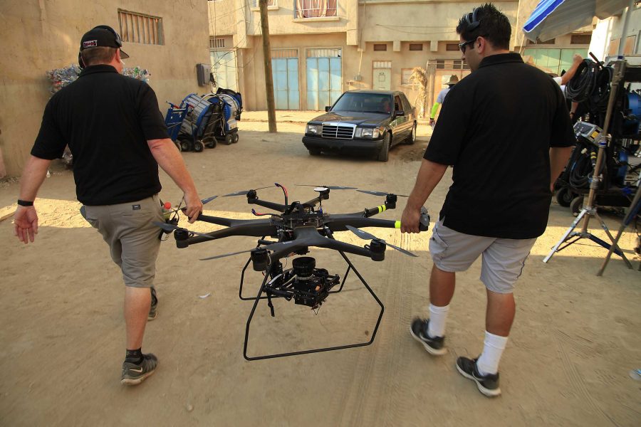 Steve Blizzard, left, and Tony Thompson of Aerial MOB carry away their drone used to film a scene on the set of Criminal Minds: Beyond Borders on Sept. 9, 2015 in Santa Clarita, Calif. The eight-rotor model is capable of carrying a 22 lb. camera and flying at 40 mph. The company, with offices in Los Angeles, San Diego and Vancouver, provides unmanned aerial cinematography services. (Myung J. Chun/Los Angeles Times/TNS)