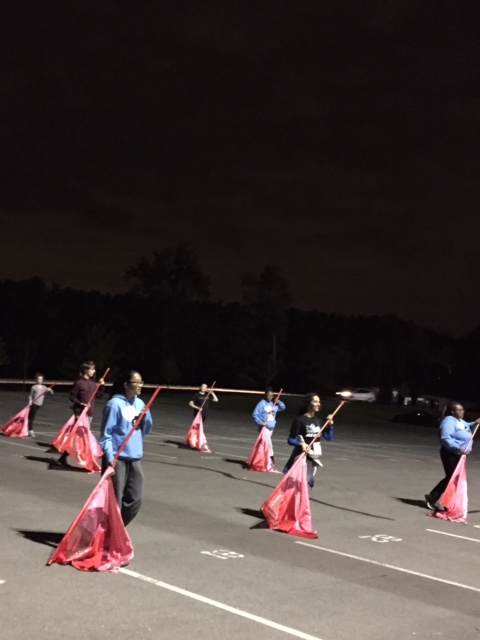 The guard practices movement three with red shiny flags. This piece will finish off this year’s show titled, “That’s a stretch”. Movement three also has PVC props and features a fast tempo. 