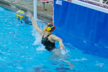    Abigail Hausfeld dives to block a shot. As a sophomore, Hausfeld is the starting Varsity goalie. She also plays with the Moose Water Polo club team. Photo by Dale Horne.