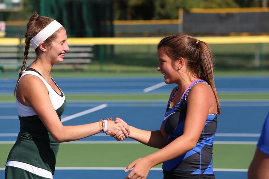 Senior Melissa Goodman shakes her opponent’’s hand prior to their match. Each match, the captains of each team call out the student playing each position on the team before the players begin their match. Goodman played first doubles during the season.