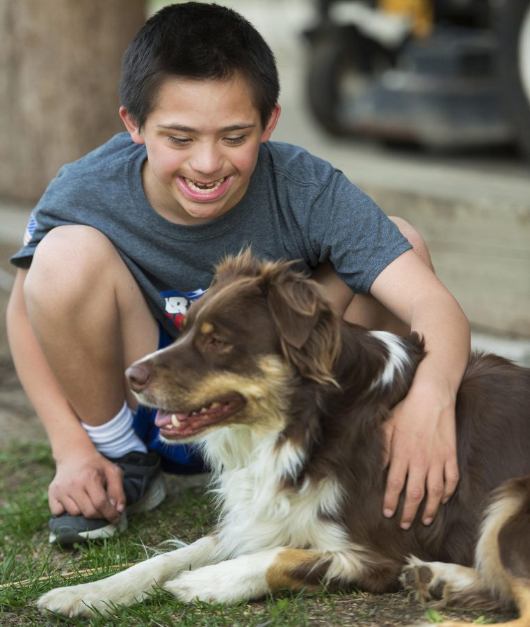 Now happy and healthy, Govi, 11, recently played with his "best friend," his dog, Jeter, on his family's farm in Platte County, Mo. (Tammy Ljungblad/Kansas City Star/TNS)