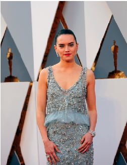 Daisy Ridley poses on the red carpet at the 2016 Academy Awards.  She is known for being the main female protagonist for the new Star Wars movie sequel “The Force Awakens.”  This is her first feature film.