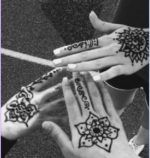 Friends pose for a picture of their henna at Relay for Life. At Relay for Life, students participated in many fun activities, including getting henna. The practice has been going on for thousands of years. 