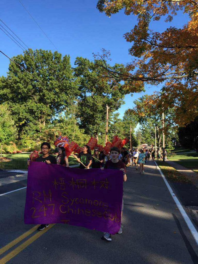 Chinese Club marches in the Homecoming Parade holding up a Chinese Club sign and Chinese dragon. The Homecoming Parade took place on October 8. The dragon was put together at the prior Chinese Club meeting. 