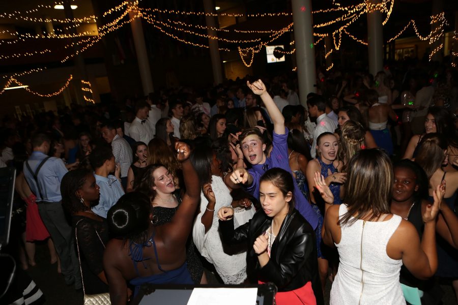 Dancing the Night Away. Christian Thompson (9) points at the camera as students fill the commons dancing at homecoming on Saturday October 8th. Students danced, sang along to songs, talked, and greeted the homecoming court at the 2016 homecoming dance. 