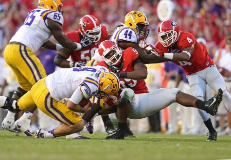 Caption: Louisiana State University is doing something during a game on versus a team. Due to extreme weather conditions, they had to cancel a game versus Florida and had to reschedule for Noveber 19 and change the location from at Florida to at LSU. This controversy and decision was highly publicized since neither side could agree on a solution. 
