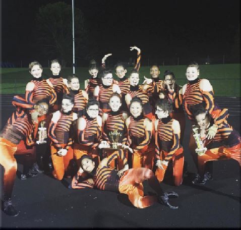 GO TEAM.The color guard poses with their trophy, showing they received first place. The group has worked really hard trying to improve their show, Vortex. Even after adding more to the show, they are already are 
incorporating other new parts.