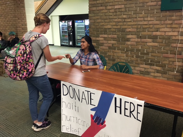 Junior Lalitha Konda works at the French department’s Haiti collection table in the Commons. Over $100 were raised during lunch, but the vast majority of the funds came from French students personally collecting of donating. The week-long fundraiser for HavServe produced $2100.
