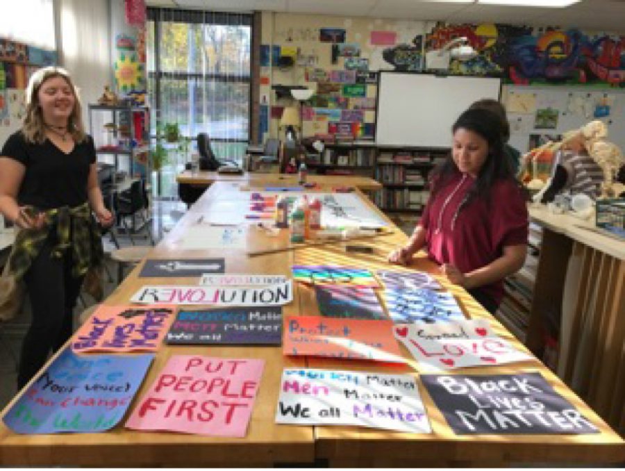 art rooms to paint posters for The Wall.  Over twenty students stayed after, filtering in and out of the room to help craft The Wall. “The purpose of the wall was to draw attention to social issues and spread positivity and I think that’s really important right now” said Stephanie Mather, 12.