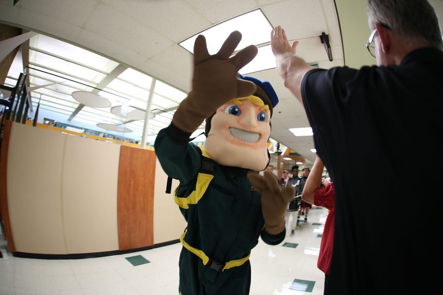 GO AVES! Aviator Mascot walks down the hall during the march of champions for the National merit students. The march of champions happens for academic award winners, sports teams and other special groups. It featurres the band the aviator mascot and all of the students out in the hallway cheering on the parade of people as the march as champions. 