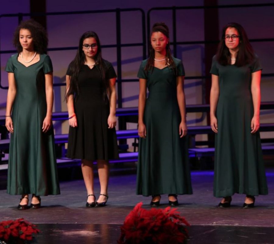 Sing out. Left to right: Elizabeth Gerci, Kennedy Byrd, Olivia Eppert, Simran Bhola, Zarria Gray, Nathalie Delgado, and Miriam Chowdhury. Bella Voce wear their green dresses at the last concert. The girls in black are also in another choir. Photo courtesy of McDaniels’ Photography.