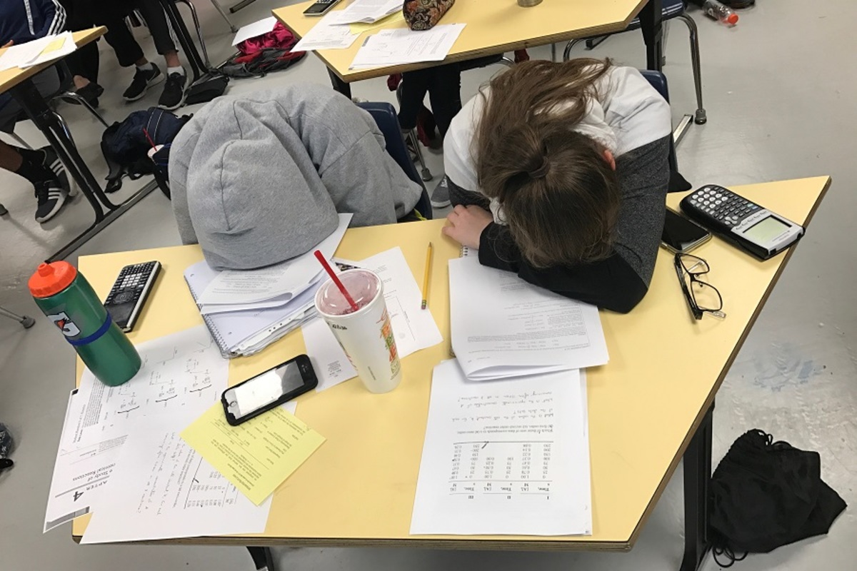 BRAIN FRIED. Two AP Chemistry students rest during the optional Saturday of instruction on kinetics. They, alongside over 15 others, spent over five hours learning about reaction rates and other related concepts. Mr. Michael Geyer taught more complex concepts that are likely not to be on the AP Exam to students who stayed after the session over.