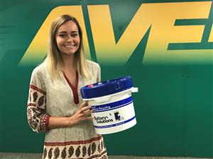 RECYCLE. Senior Alexandra Meckes poses with one of the containers for batteries. As she continues her project, she finds herself with an abundance of support by Sycamore-affiliated people. She hopes to see many more people getting involved and participating in recycling their used batteries.