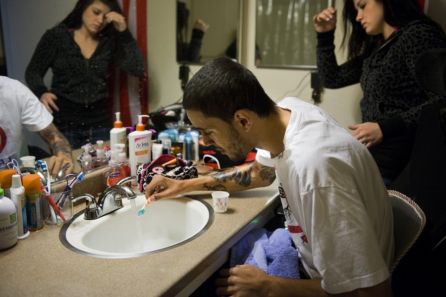 Devin Johnson brushes his teeth as his girlfriend and caregiver, Tayler Miller, assists on January 11, 2013. Johnson recently learned to grip the toothbrush well enough to perform the task. (Autumn Payne/Sacramento Bee/MCT)