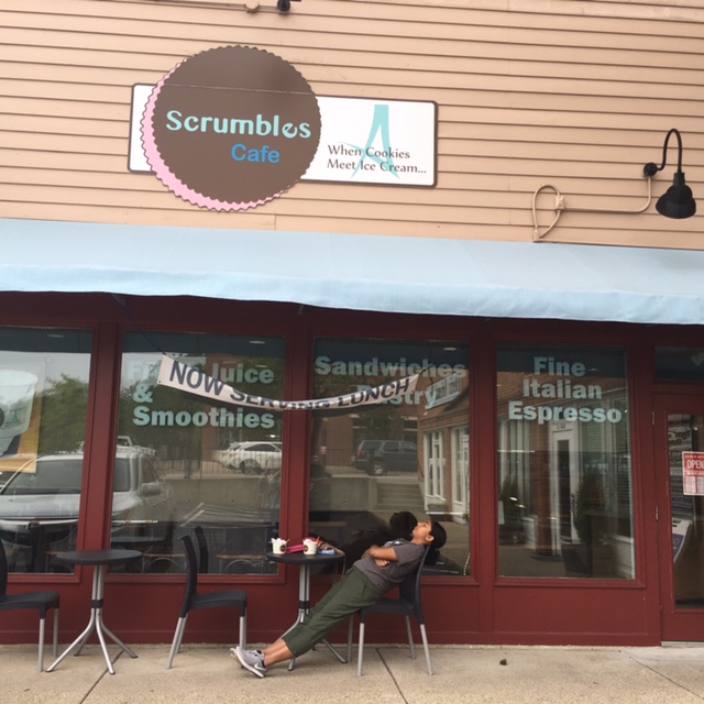 RELAX. Junior Adhiti Chundur lounges in the sun upon the completion of a gelato cookie sandwich from Scrumbles Cafe. Scrumbles is a fairly new cafe and ice cream parlor located in downtown Montgomery. While eating may be messy, it makes the best distraction from the stress of rounding out the school year. Photo courtesy of Jenna Bao.