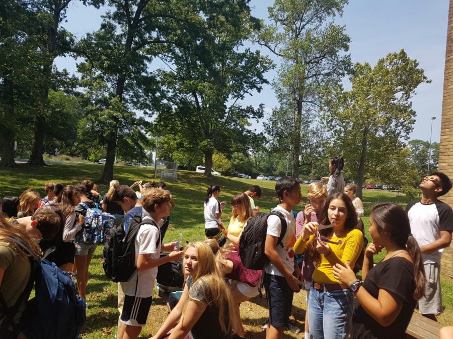 ANTICIPATION. Seventh bell science classes view the eclipse through their special protective glasses. At SHS, students and teachers were in the path of 91 percent totality. The eclipse reached its peak at 2:29 p.m. Photos courtesy of Adhiti Chundur. 
