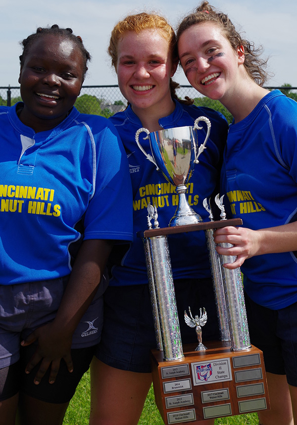 STATE CHAMPIONS. Wadi Aburas (left), Izzi Gibbon (center), and Goldenberg (right). Zoe holds the state championship trophy- her team won state with a score of 47 to 5. “After all of my team’s hard work and effort, we finally have earned a state title,” Goldenberg said. 
