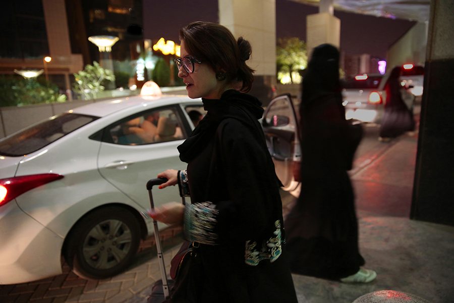 FINALLY. A women in Saudi Arabia waits for Uber to pick her up. The royal decree released on Tuesday will allow Saudi Arabian women to drive in June 2018. Until then, women will continue to pay for drivers or ask male relatives to drive them places.