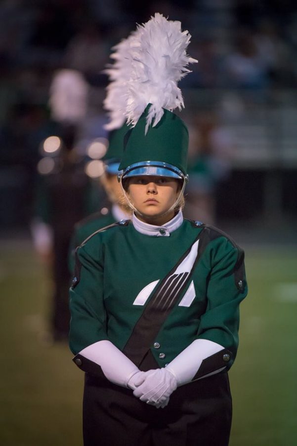 GET READY. Freshman Lucinda Cooke stands at low before the start of their competition. The band competed at Mason High School on Sat., Oct. 21 and received Grand Champion. Now they are working on making their show better and increasing their performance.
