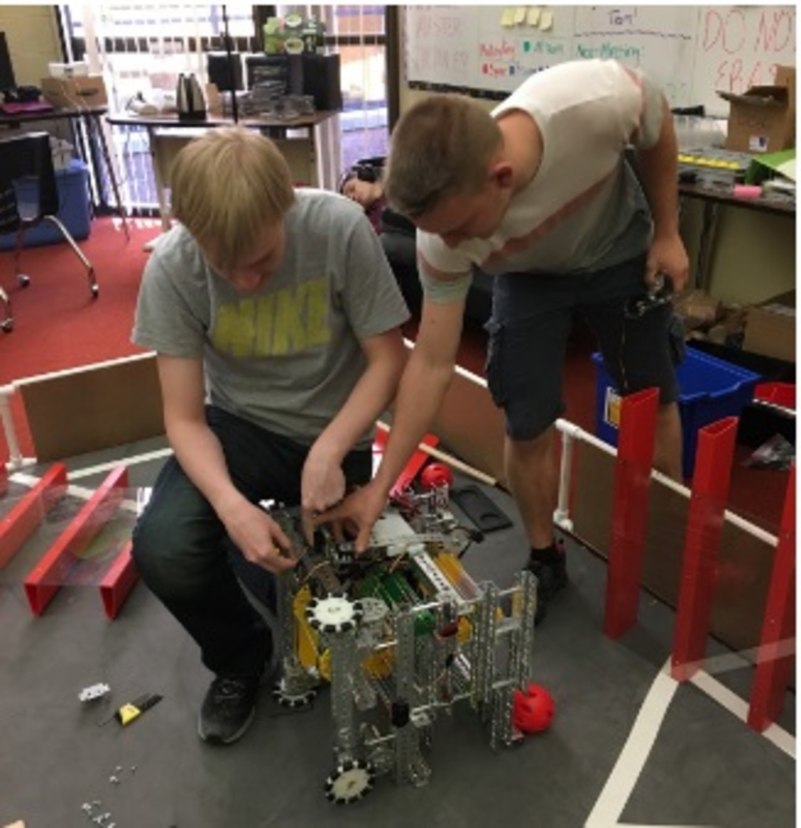 PROGRAM. Juniors Nick McDonough and Phil Bryant work on their robot during first Aves bell. Both students have a love of Computer Science and Programming, and although Bryant is new to the club, he has had experience building computers on his own; furthermore, he was a member of his old school’s Science Olympiad Team. “I build computers as a hobby, but I've not really done robotics, so it's nice being able to come in and being able to work during Aves bell,” Bryant said.