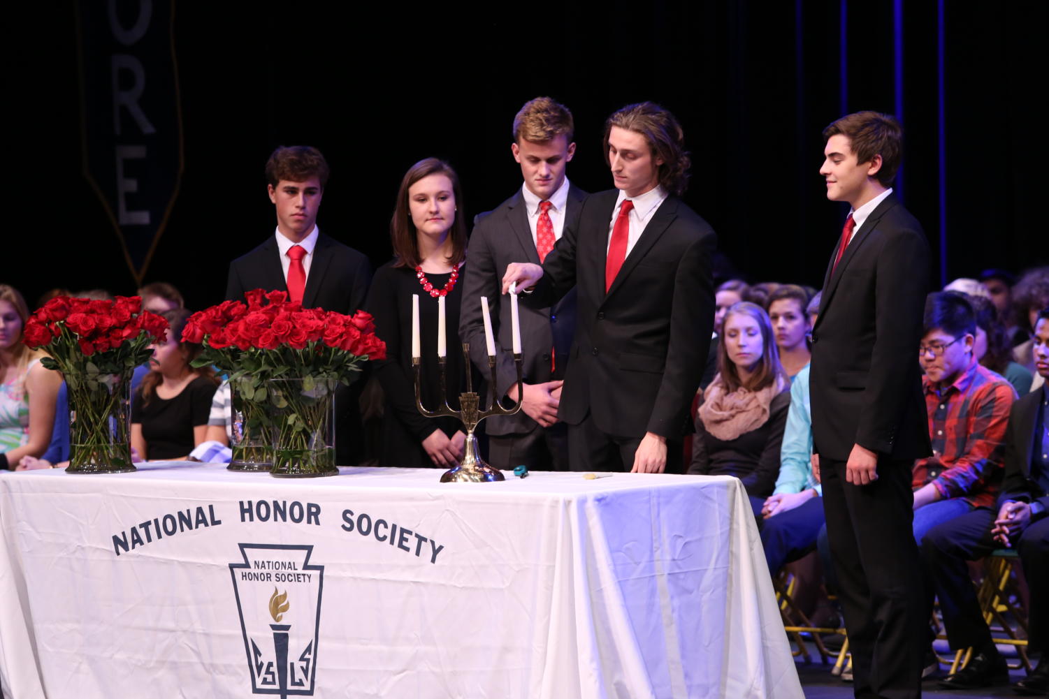 GETTING LIT. During the ceremony, NHS leaders light students’ candles to symbolize their induction into NHS. “I’m thrilled to see watch our hard work come into action on induction night. When I was inducted last year, the sponsor speeches were especially touching. I’m looking forward to hearing them this year from our new members,