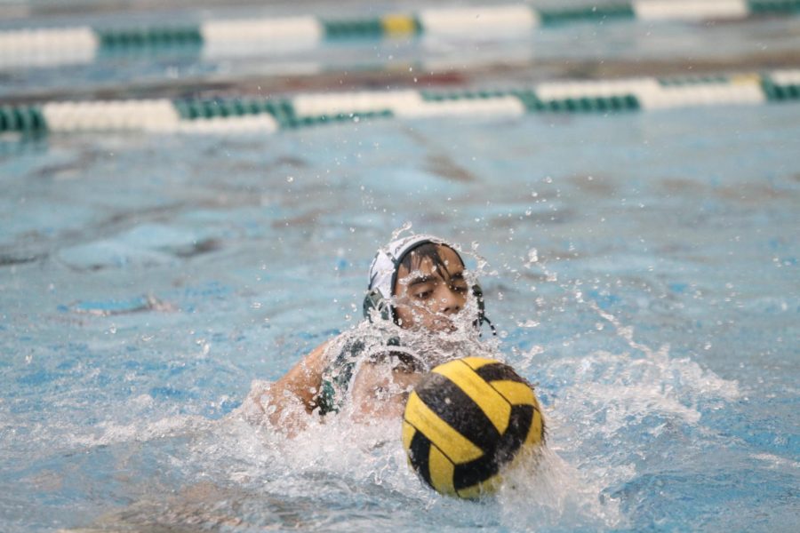 MAKING A SPLASH. At water polo practice, an offensive player gets the ball while defensive player, Aryan Godha, puts pressure on him. This demonstrates the aggressive nature of water polo--even at practices. Fribourg shares that he got his concussion while at practice. 
Photo courtesy of McDaniel’s Photography