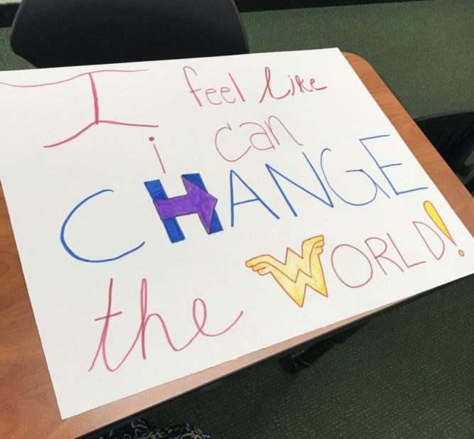 CALL TO ACTION. Juniors Nandita Kulkarni and Allyson Bonhaus made this sign for the march during a He For She meeting. This year’s Women’s March focuses on women taking political action especially through voting in 2018. 