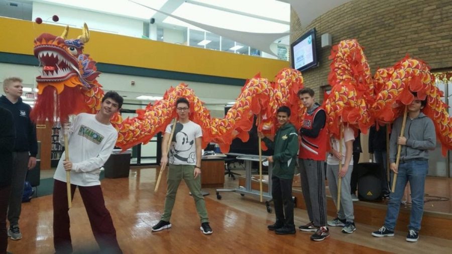 CELEBRATING CULTURE. Students in Chinese class perform with Chinese Club’s traditional dragon costume. The dragon dance is traditionally performed during the Lunar New Year, but the dragon is an important element of the culture in general. Language clubs are celebrated on the first day of the Diversity Week, March 19. 