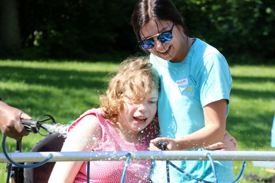 FUN IN THE SUN. Students enjoy a water station at last year’s Adaptive PE Field Day. This event would not be possible without help from volunteers. If interested in volunteering at the event, please contact Mrs. Paula Anstaett. 