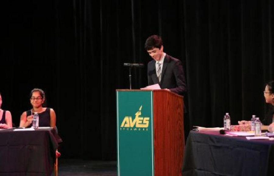 SPEAK UP. Junior Grant Brunner speaks at debate finals during last year’s competition. Although most teachers do not allow students to pick their own groups for debates, debates are truly a team effort. Group members must rely on one another to connect speeches and write the rebuttal. 