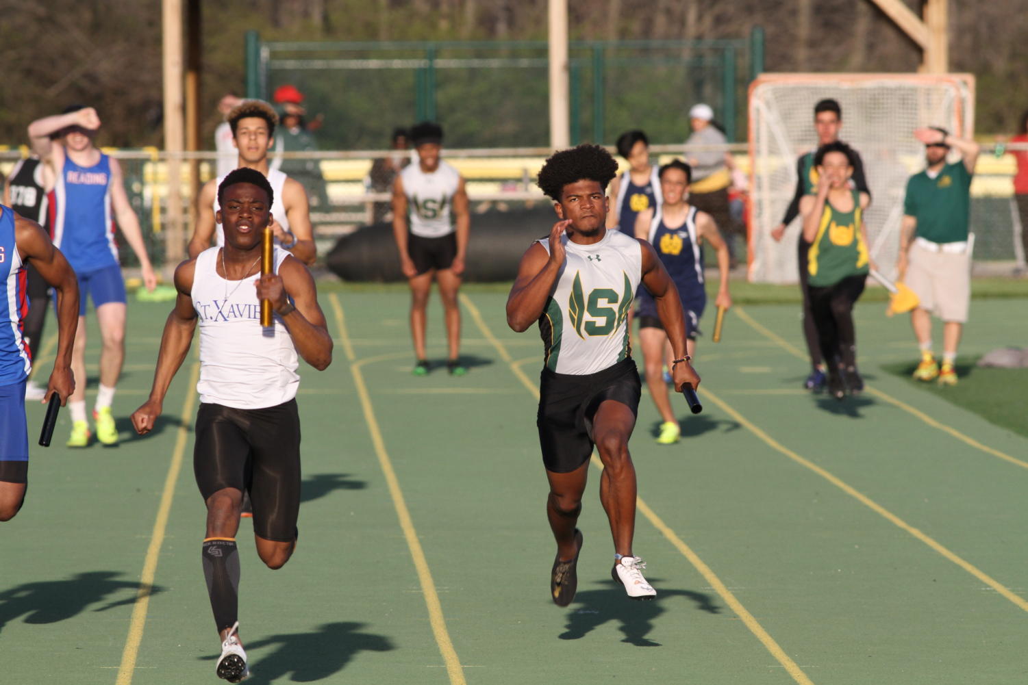 KEEP RUNNING. Senior Jonathon Malek competes in the 4x200 relay. Last year, Malek won state with senior Asa Hodrick. They won the 4x200 relay, so they were determined to qualify again this year.