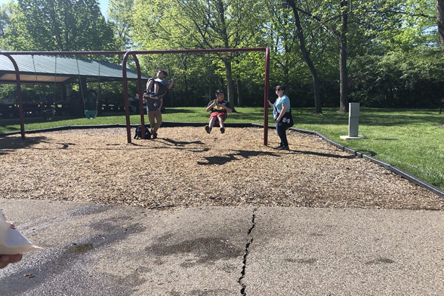 SWING. When taking a break from walking and enjoying stations, students chose to swing. Field day took place at the park near the Blue Ash Recreation Center. Students from different schools within the district attended, including the junior high and elementary schools. 