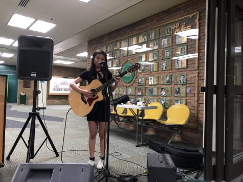 SING, SING, SING. Senior Yvanna Reyes sings a song while playing the guitar at the Senior Art Show on May 4. Senior Keren Idelman-Sidenko played a piano accompaniment. Though the art show was officially from 5:00 to 7:00 p.m., the art pieces will continue to be on display during the week.