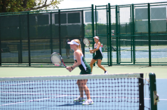 EYES ON THE PRIZE. Seniors Helen Sotropa and Amanda Wilson are pictured whilst playing a focused doubles match from the prior season. The team will notably face longtime rivals Mason on Sept. 4, and continue preparation for the Greater Miami Conference (GMC) tournament as well as the Coach’s Classic tournament later in the month. 