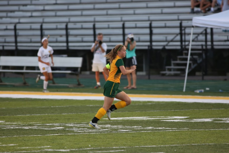DARTING. Three year varsity starting midfielder, senior Hannah Kirkham, sprints after the ball in the home match against Walnut Hills. The team went on to defeat Walnut Hills 5-0 and they are currently 7-1-2. “I think senior night is a great way to recognize the end of a chapter. It’s easy to get caught up in the excitement of what’s coming next, but it’s just as important to look back on on all the things we have accomplished this season and the people that we have accomplished them with. This year especially we’ve gotten to become a really close knit team so it’s definitely going to be a special night,” Kirkham said.