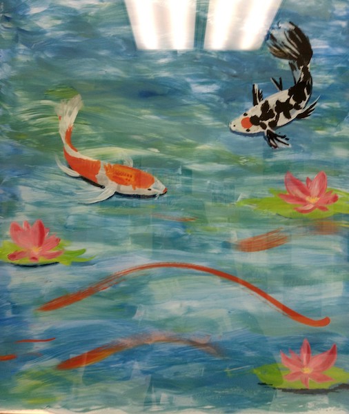 A recently painted mural decorates the window of a counseling office, painted by a volunteer student artist. 
   
