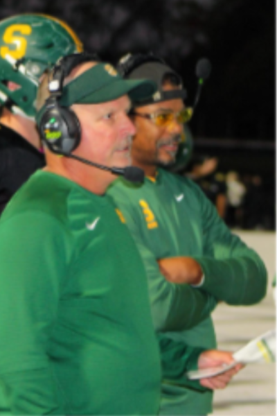 Coach Datillo (left) looks on during a game