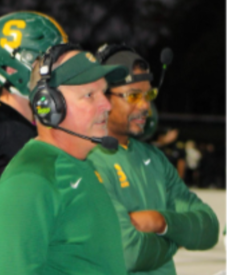 Coach Datillo (left) looks on during a game