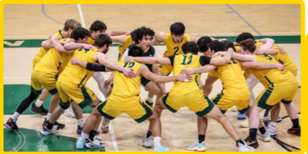 Boys' Volleyball Team huddling in the middle of a game