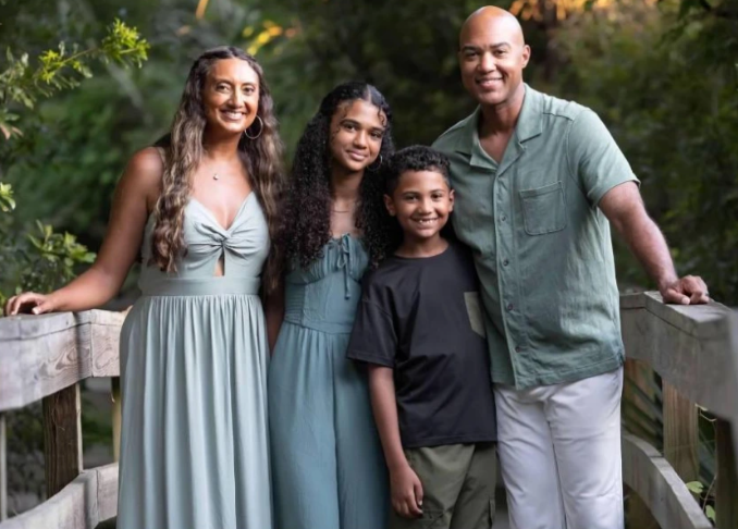 Layla Parker, 9, poses for a family photo with her mom, dad, and brother.