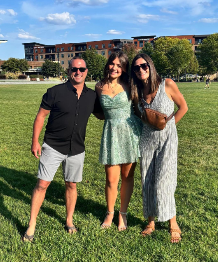 Zoey Tatarko, 9, takes part in a family photo with her parents.