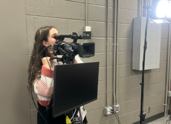 Skye Boymel, 10, films footage for the Broadcast Club's weekly video.